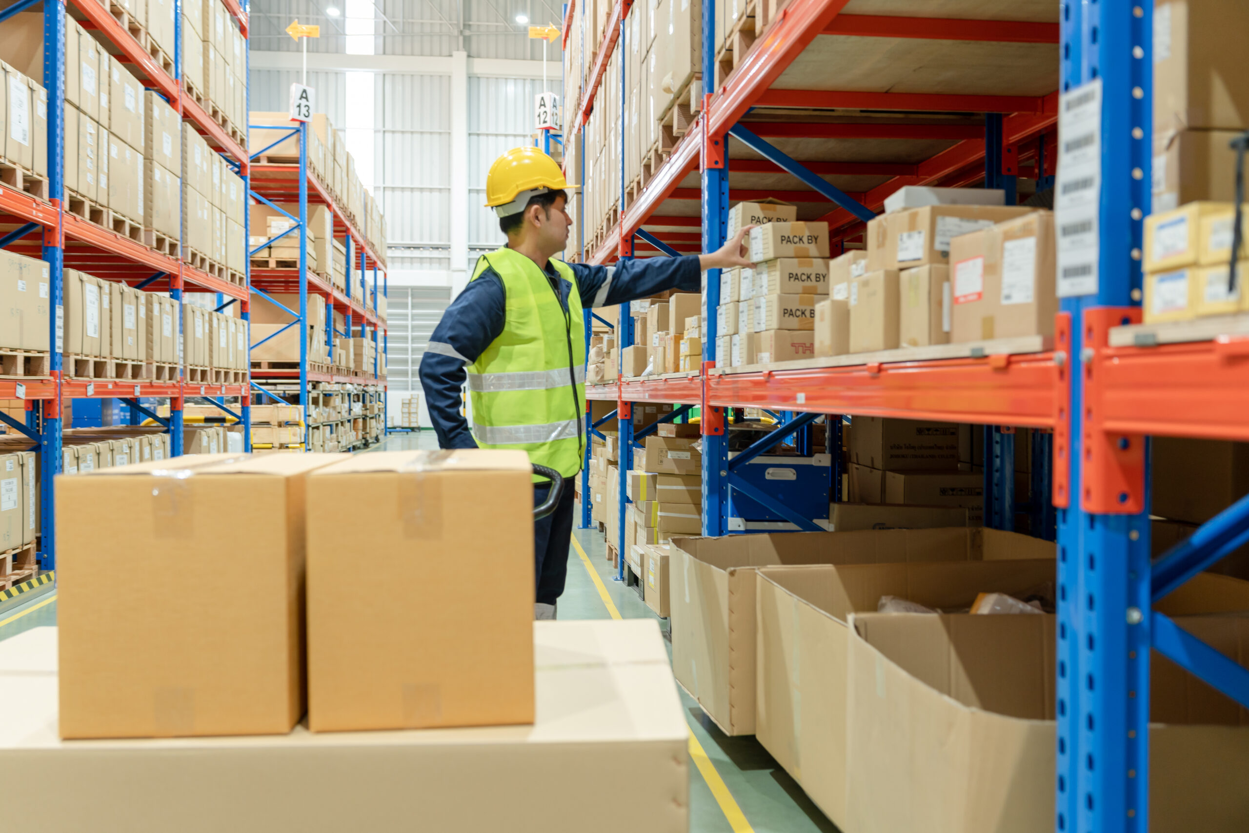 Asian male factory manager inspect goods in warehouse or inventory and check stock product. Transport logistic business shipping, delivery to customers through a freight forwarding company. inspection