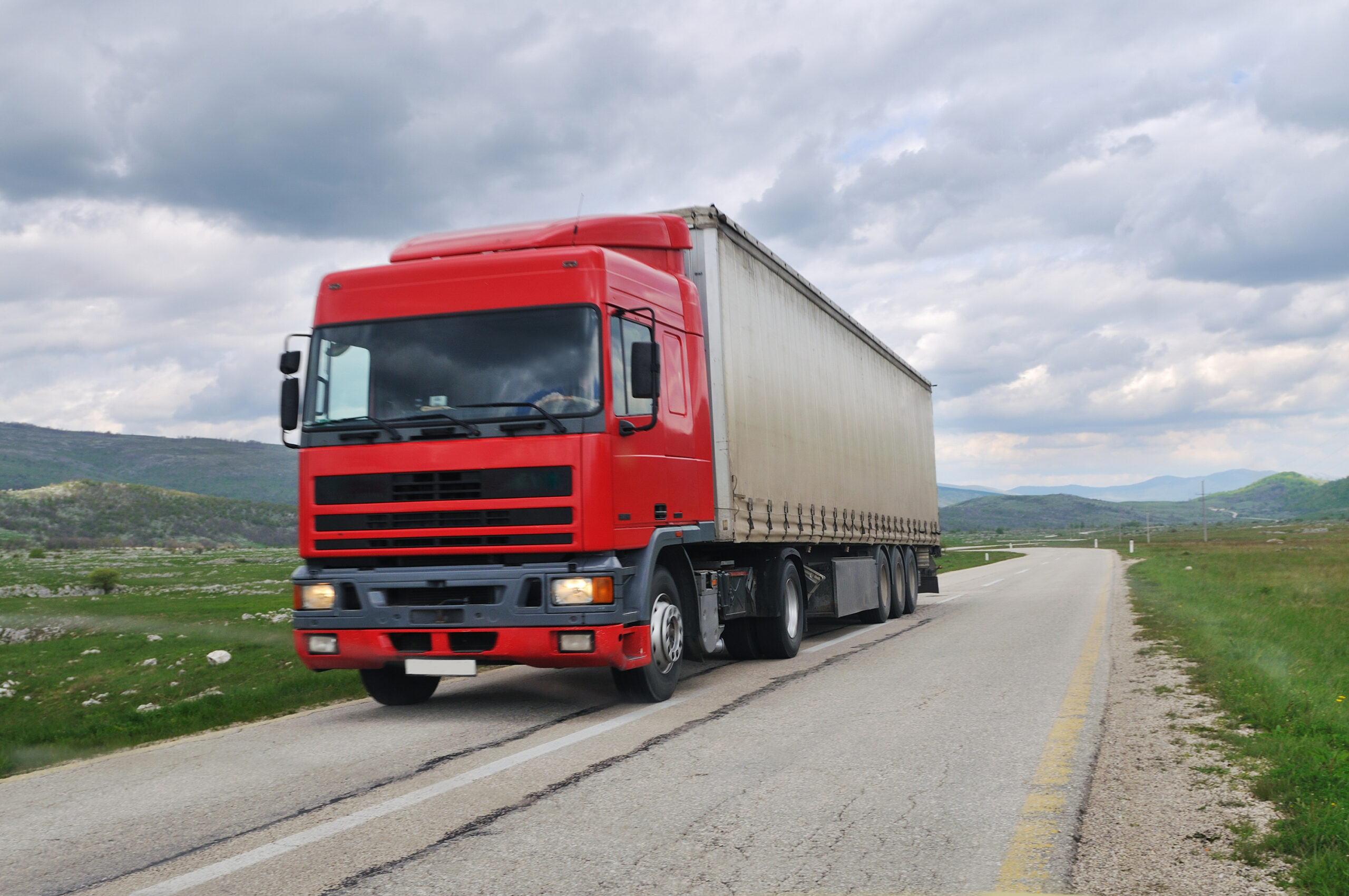 big delivery cargo  red truck on road drive fast